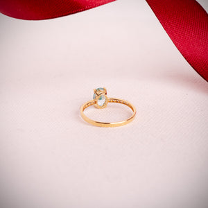 Anillo con topacio paraíba y circonitas en oro 18k bicolor