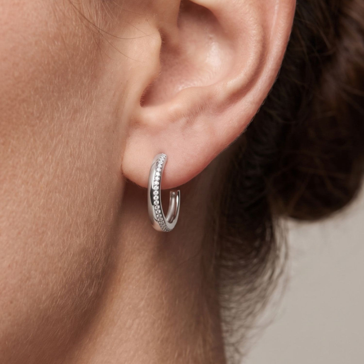 Criolla abierta de plata de ley 925 con carril de circonitas de 4 mm de ancho y 18 mm de alto puesta en la oreja