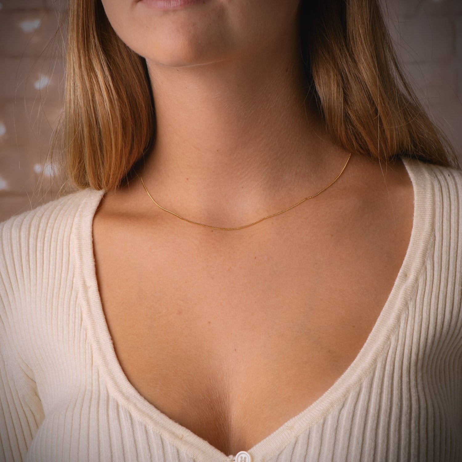 Cadena de oro 18k barbada maciza de 0,8 mm puesta al cuello