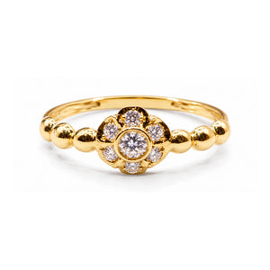 Sortija de oro 18k con flor de circonitas y brazo decorado con bolas