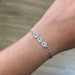 Pulsera de plata de ley 925 con tres circonitas color aguamarina y orla de blancas