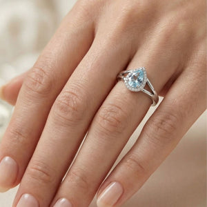 Anillo de plata de ley 925 con circonita aguamarina orlada y brazos cruzados
